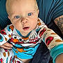 baby, child, blue_eyes, pajamas, cookie_monster, elmo, drool, tattoo, person, arm, clothing, hand, face, indoor, closeup, cute, infant, looking_at_camera, sitting, holding