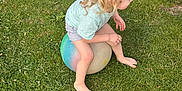 Raiden is registered to the contest to win money with this photo: child, toddler, grass, ball, barefoot, curly_hair, outdoor, play, summer, shorts, tshirt, greenery, nature, park, fun, kid, side_view, toy, barefoot_child, recreation