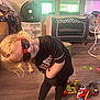 Raiden is registered to the contest to win money with this photo: child, sunglasses, toy, floor, fan, crib, room, playful, barefoot, smile, indoor, clothing, blonde_hair, casual, wooden_floor, colorful, baby_items, furniture, person, leisure