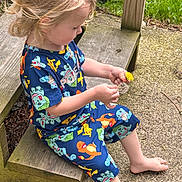 Raiden joined the competition — help win amazing prizes! child, toddler, curly_hair, blonde_hair, pokemon_pajamas, sitting, wooden_steps, outdoor, flower, dandelion, barefoot, grass, concrete, nature, playing, casual_clothing, daylight, cute, exploring, person