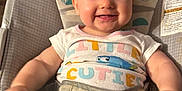 Lyla joined the competition — help win amazing prizes! animal_print, baby, baby_seat, child, clothing, colorful, cute, face, happy, indoors, infant, monkey_illustration, onesie, pajamas, pattern, person, seat, smiling, sun_illustration, turtle_illustration