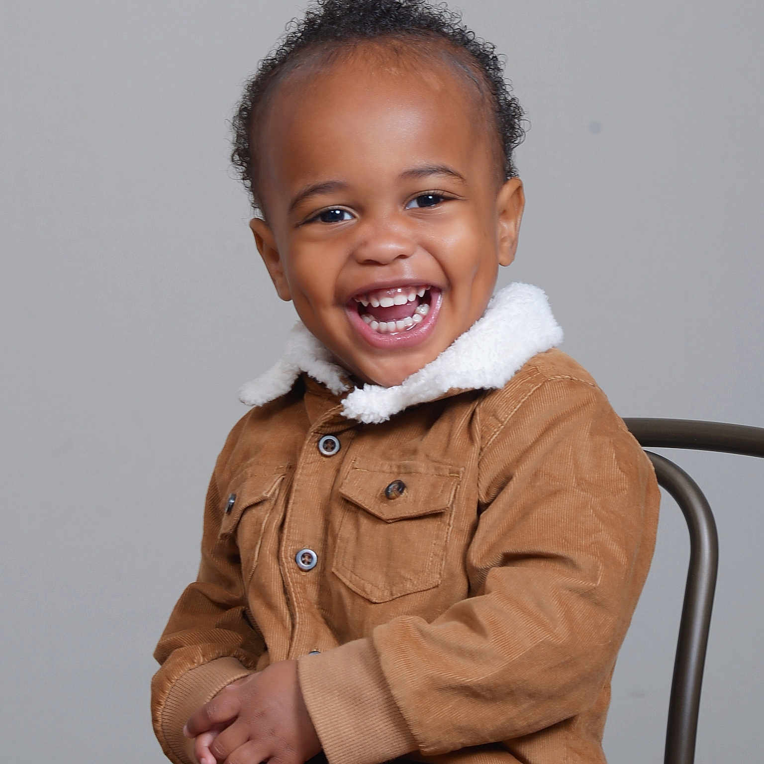 Mars Legend is registered to the contest to win money with this photo: baby, babylaughing, bodypart, clothing, coat, face, finger, hand, happy, head, jacket, laughing, longsleeve, overcoat, person, photography, portrait, sitting, sleeve, smile