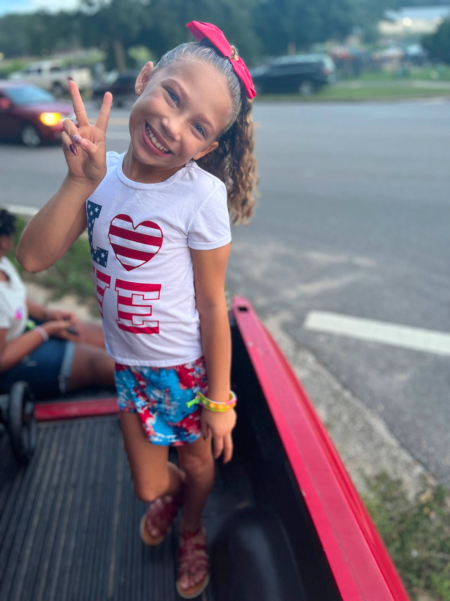 Nevaeh is registered to the contest to win money with this photo: child, cool, event, eyewear, family_car, flip_flops, fun, happy, human_leg, joy, leisure, luxury_vehicle, person, recreation, sandal, shorts, smile, t_shirt, thigh, toddler