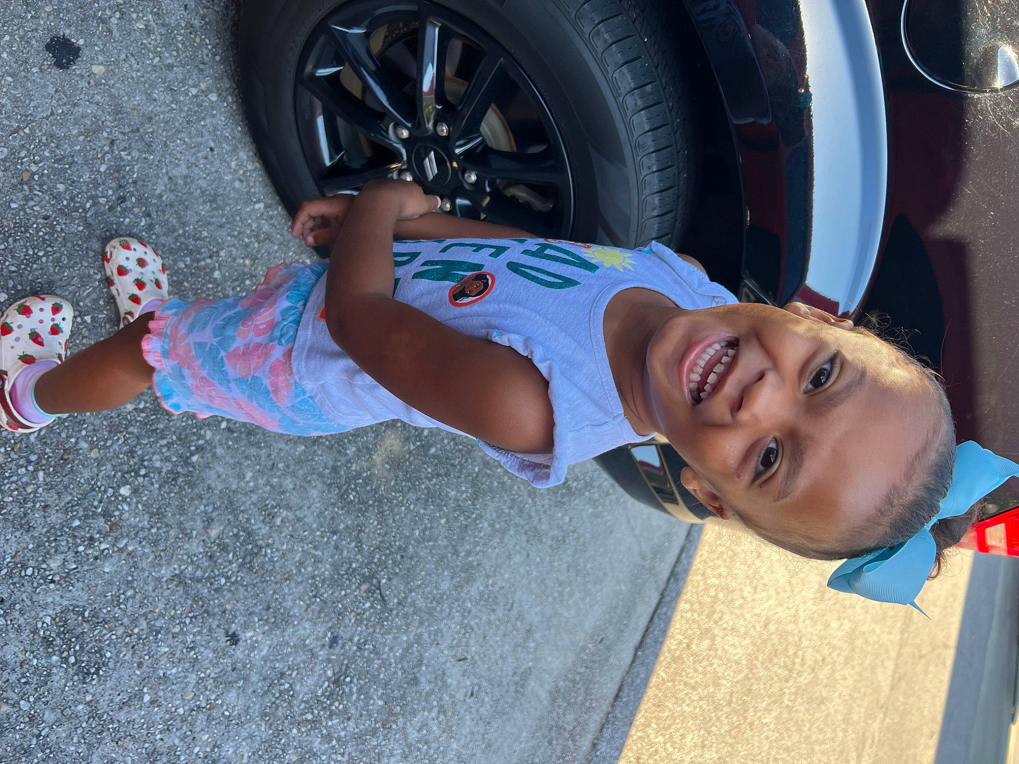 Azariah joined the competition — help win amazing prizes! asphalt, automotive_design, automotive_exterior, automotive_lighting, automotive_tire, fender, hat, joy, leg, motor_vehicle, person, shoe, shorts, smile, sneakers, sunglasses, thigh, tire, tread, vehicle