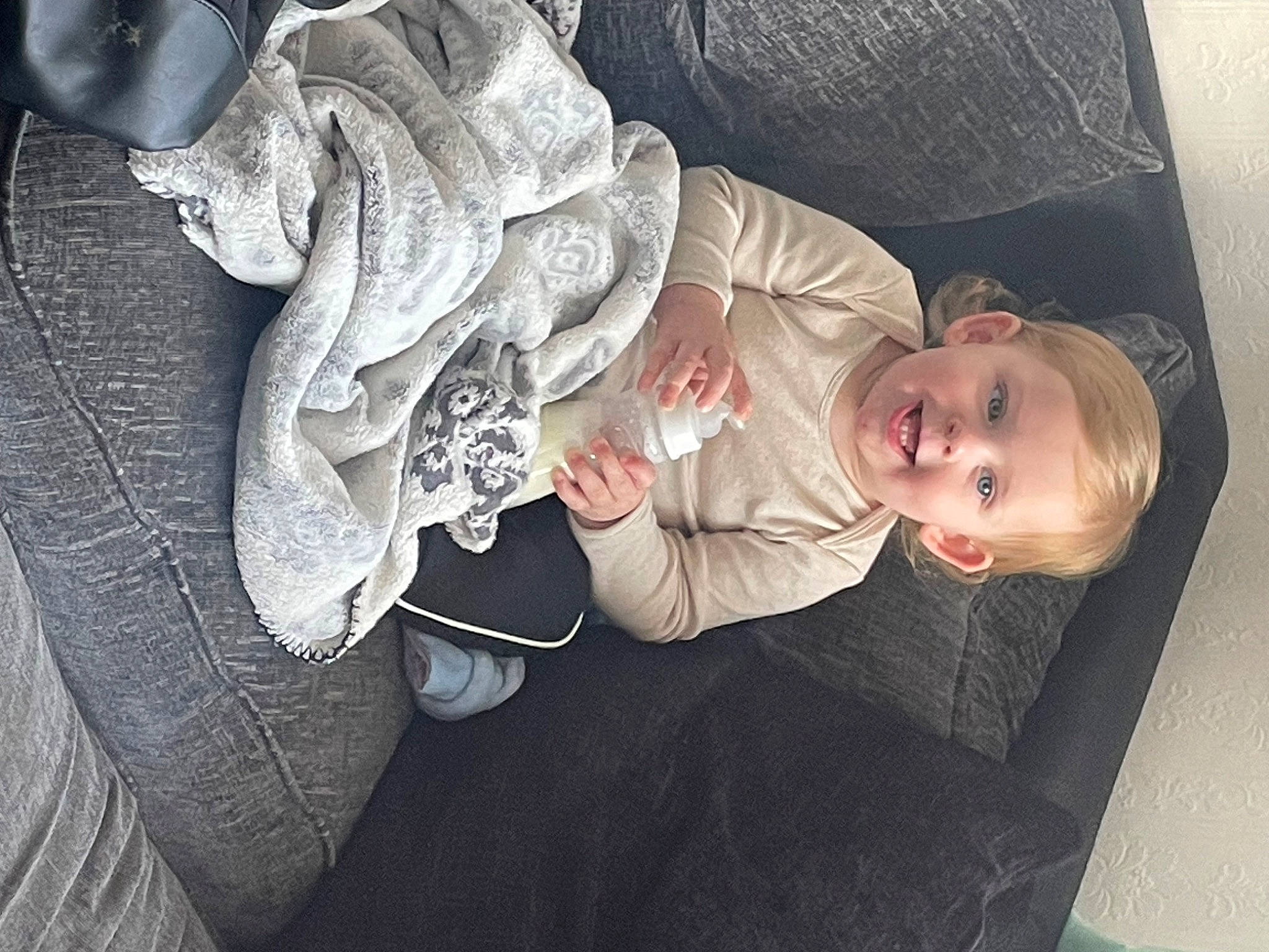 Alistair is registered to the contest to win money with this photo: baby, baby_products, baby_toddler_clothing, child, comfort, couch, flooring, happy, hat, joy, linens, nap, person, petal, room, sitting, sleep, smile, sun_hat, toddler