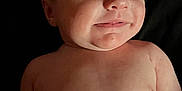 Ethan joined the competition — help win amazing prizes! baby, smile, face, skin, head, eyes, mouth, infant, child, portrait, expression, cute, cheek, human, newborn, lying_down, bare_chest, hand, background, dark