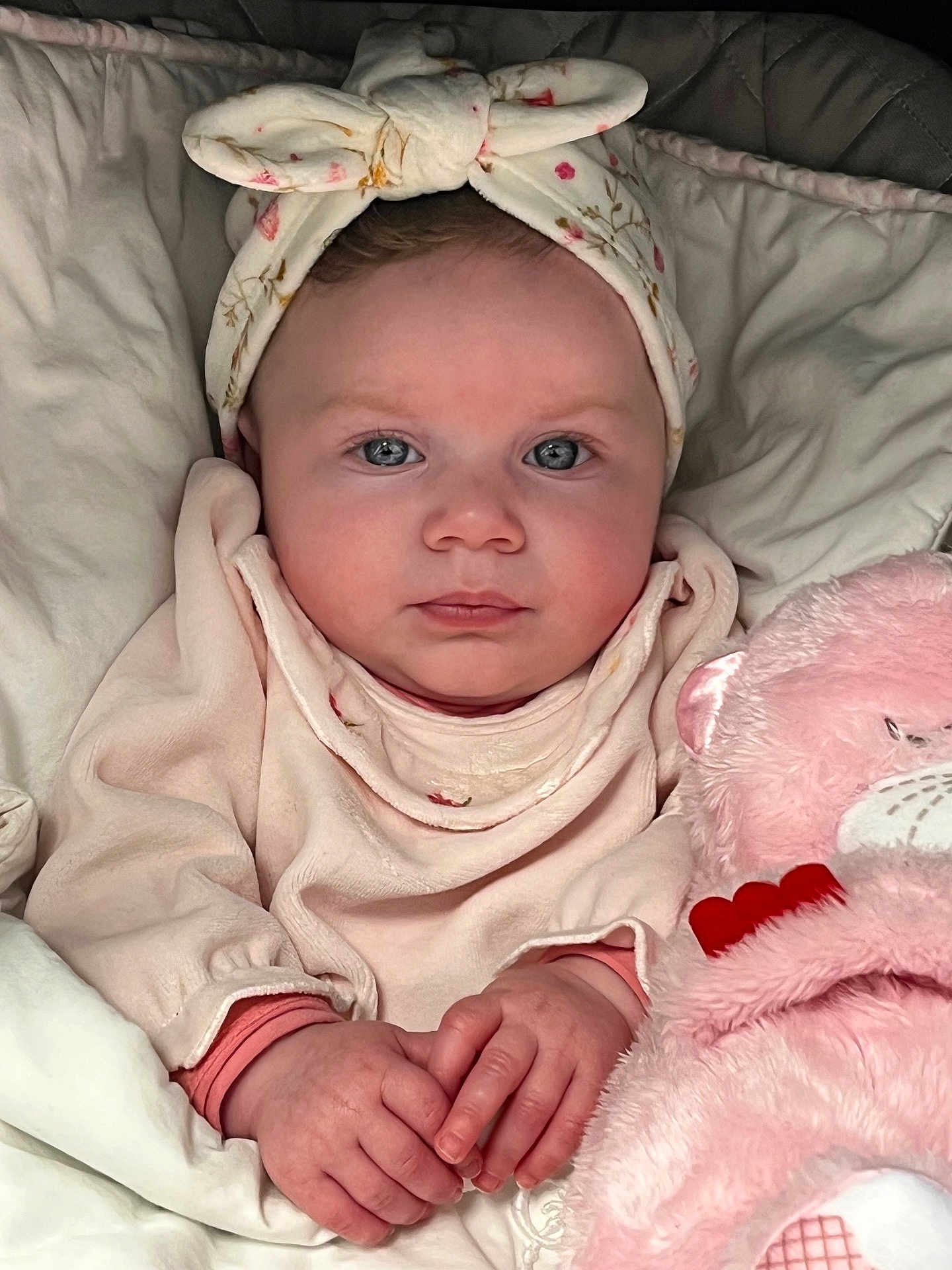Maddy participe au concours pour gagner de l'argent avec cette photo : baby, infant, headband, blue_eyes, blanket, pink, plush_toy, teddy_bear, clothing, cute, child, portrait, hands, soft, comfort, indoors, person, face, newborn, cozy