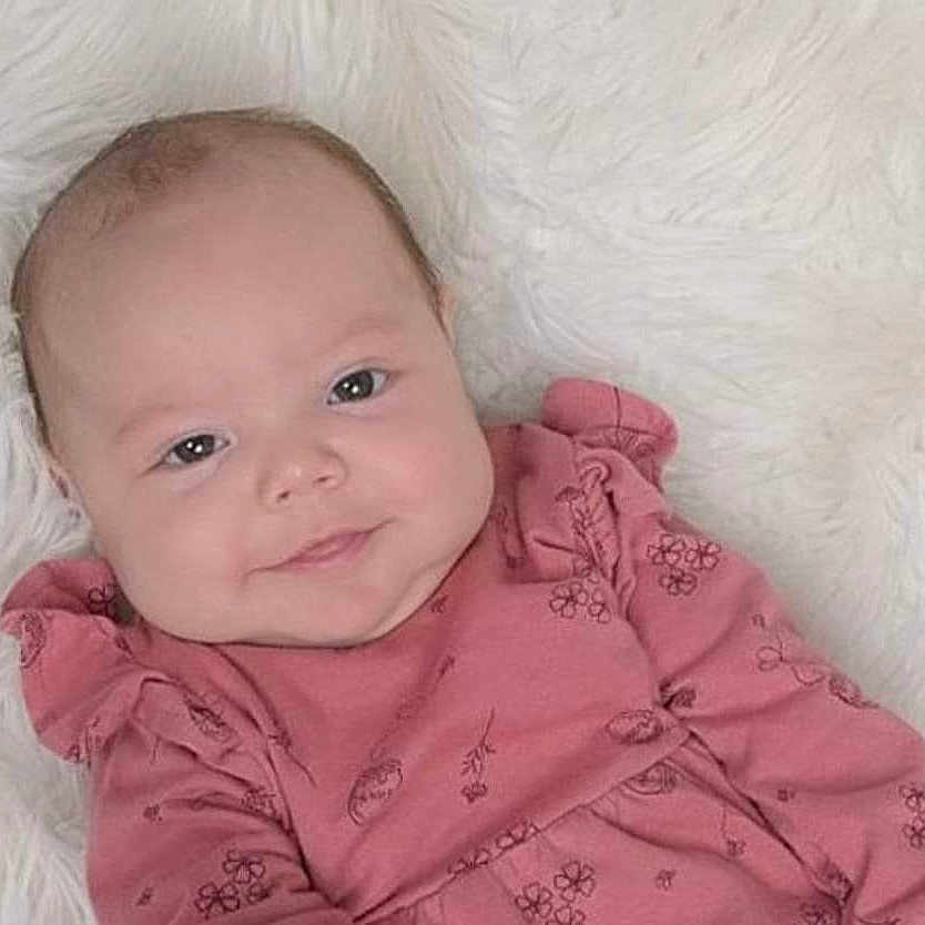 Luna joined the competition — help win amazing prizes! baby, babylaughing, blanket, blonde, clothing, coat, cushion, face, hair, happy, head, homedecor, jacket, newborn, person, photography, portrait, quilt, sleeve, smile