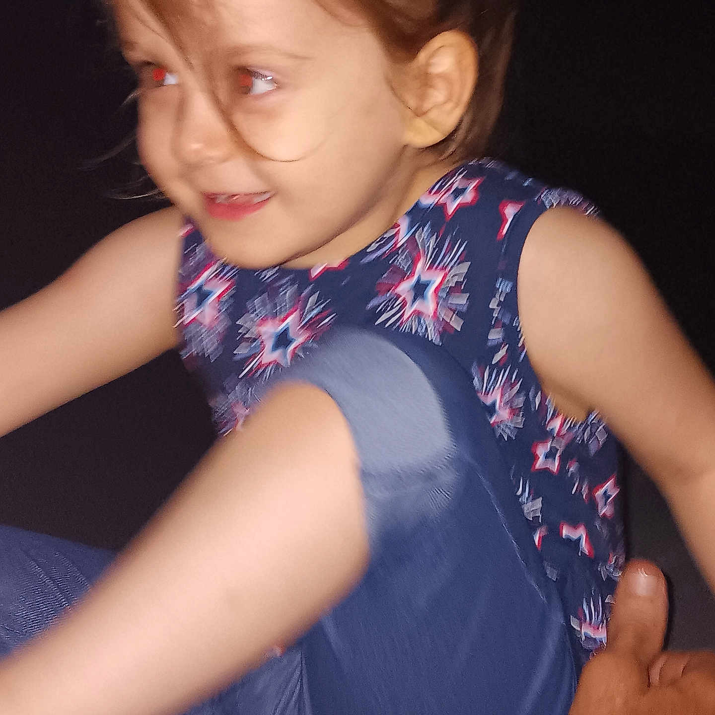 Gracielynn joined the competition — help win amazing prizes! child, kid, red_eye, star_pattern, clothing, pants, blue, smile, playful, hand, plush_toy, dark_background, motion_blur, face, person, casual_wear, young, indoor, portrait, cute