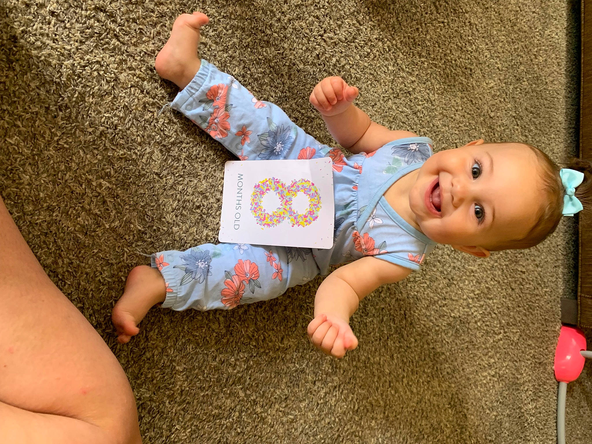 Isabel is registered to the contest to win money with this photo: baby_toddler_clothing, barefoot, child, finger, flooring, foot, fun, gesture, grass, hand, happy, human_body, joy, leaf, leg, person, skin, sleeve, smile, sock