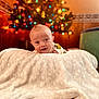 Kolton joined the competition — help win amazing prizes! baby, blanket, christmas_tree, colorful_lights, cozy, indoor, smiling, happy, infant, portrait, holiday, decorations, warm_lighting, carpet, cute, child, face, festive, soft_texture, home