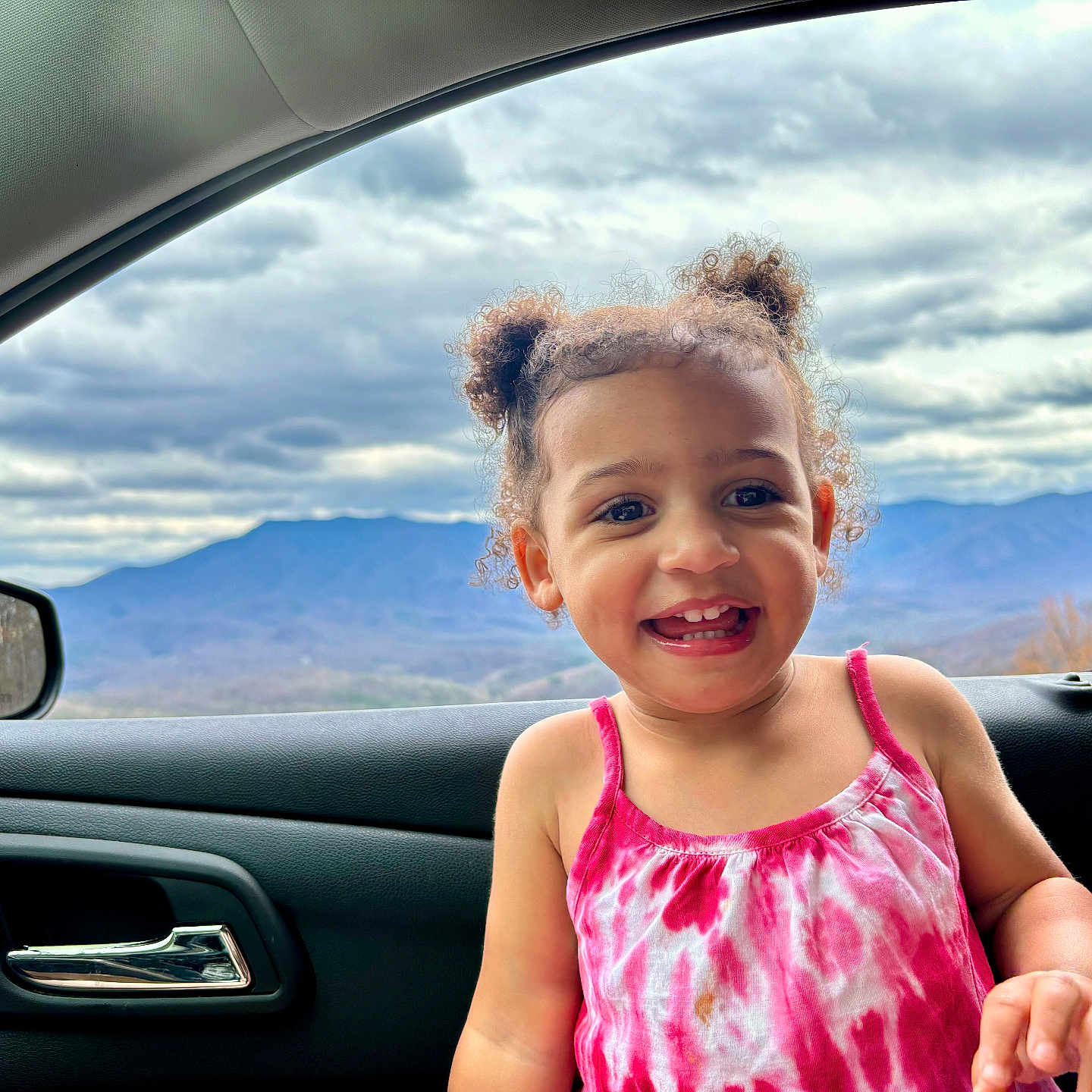 Maeve joined the competition — help win amazing prizes! alloywheel, car, carwheel, child, clothing, dress, face, female, girl, happy, head, machine, outdoors, person, photography, portrait, smile, spoke, transportation, vehicle