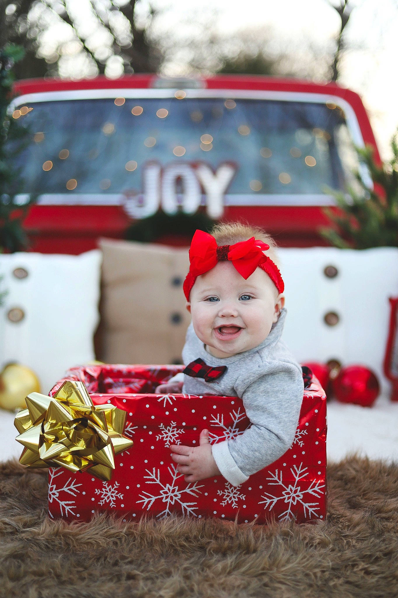 Adelynn is registered to the contest to win money with this photo: baby, child, christmas, christmas_decoration, christmas_eve, christmas_ornament, event, fictional_character, fun, happy, holiday, person, photography, plant, red, smile, snow, toddler, tradition, tree