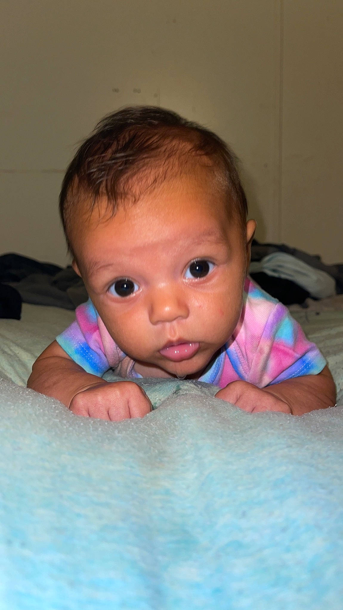 Evelyn is registered to the contest to win money with this photo: baby, baby_toddler_clothing, cheek, comfort, eyebrow, eyelash, finger, floor, flooring, gesture, hairstyle, happy, iris, lip, mouth, nose, person, skin, smile, thumb