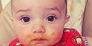 Weston is registered to the contest to win money with this photo: baby, child, face, bib, food, messy, high_chair, monkey_pattern, red_bib, cute, expression, indoor, young, person, infant, small_child, feeding, messy_face, clothing, portrait
