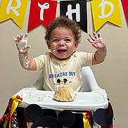 Bryce joined the competition — help win amazing prizes! toddler, birthday, cake, high_chair, smiling, hands, frosting, celebration, decorations, banner, mickey_mouse, party, happy, child, food, indoor, clothing, ribbons, festive, one