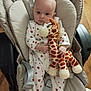 Charlie participe au concours pour gagner de l'argent avec cette photo : baby, infant, plush_toy, giraffe, onesie, heart_pattern, baby_chair, straps, indoor, wood_floor, cute, child, soft_toy, seated, person, young_child, clothing, expressionless, furniture, holding