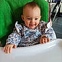 baby, child, cute, face, floor, floral_shirt, furniture, green_towel, hands, happy, head, high_chair, indoor, lighting, person, portrait, skin, smiling, table, window