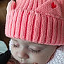baby, pink_hat, knit_hat, sleeping, face, eyelashes, hand, skin, closeup, infant, cute, warm_clothing, soft_texture, peaceful, portrait, child, headwear, love_heart, cozy, toddler