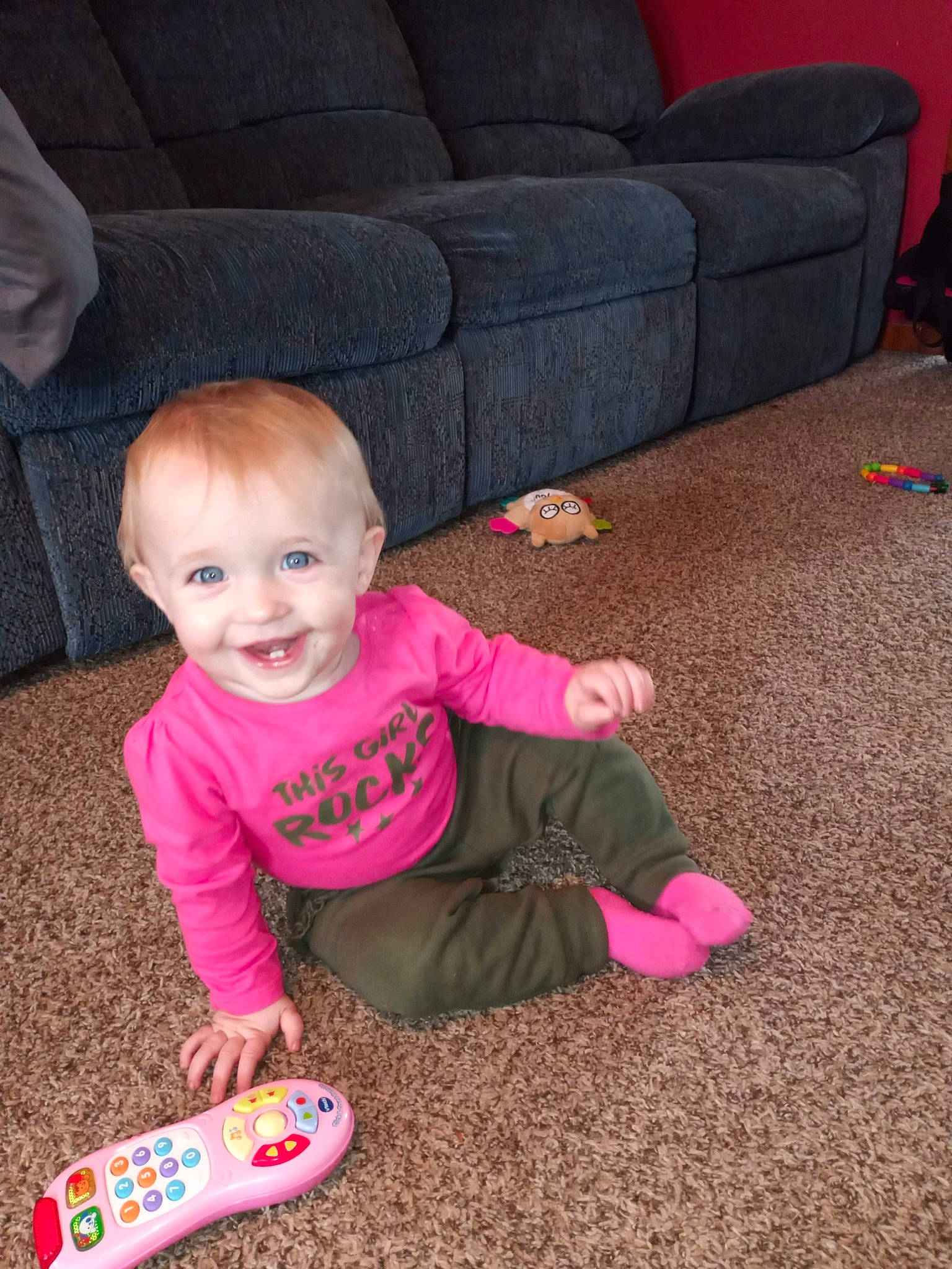 Mercedes is registered to the contest to win money with this photo: armrest, baby, baby_laughing, baby_toddler_clothing, child, comfort, couch, finger, joy, living_room, person, pink, play, sofa_bed, studio_couch, toddler