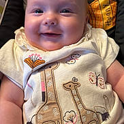 Maliyah joined the competition — help win amazing prizes! baby, smiling, infant, cute, giraffe, embroidered_clothing, butterfly, patterned_background, child, sitting, closeup, happy, cute_clothing, soft_lighting, indoor, person, head, face, arm, hand