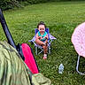 Aylanni is registered to the contest to win money with this photo: child, toddler, smiling, sitting, outdoors, garden, grass, meadow, trees, nature, folding_chair, camping_chair, pink_chair, water_bottle, summer, playful, portrait, curly_hair, sandals, backyard
