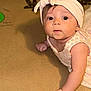 Keonna Marie joined the competition — help win amazing prizes! baby, infant, headband, dress, face, eyes, arm, hand, skin, curious, lying_down, floor, text_background, playful, cute, child, portrait, indoors, closeup, young