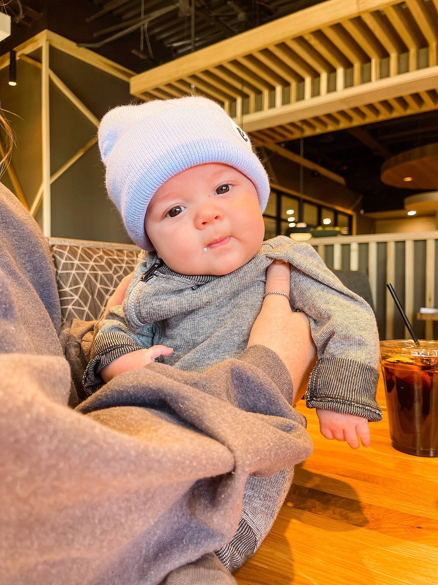 Brazos joined the competition — help win amazing prizes! baby, baby_toddler_clothing, beanie, cap, cheek, child, chin, comfort, flooring, hardwood, headgear, headwear, knit_cap, person, sitting, skin, sleeve, tableware, toddler, wood