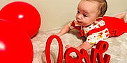Merrick joined the competition — help win amazing prizes! baby, child, red_balloons, love_sign, suspenders, heart_pattern, curious, soft_surface, indoors, decor, cute, infant, crawling, bright_colors, playful, portrait, toddler, expression, celebration, valentine