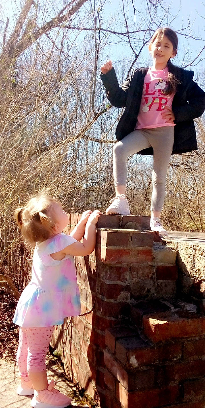 Caydence is registered to the contest to win money with this photo: arm, clothing, flash_photography, fun, gesture, hand, happy, human, human_body, joy, leg, leisure, people_in_nature, person, photograph, pink, shoe, shorts, sky, standing