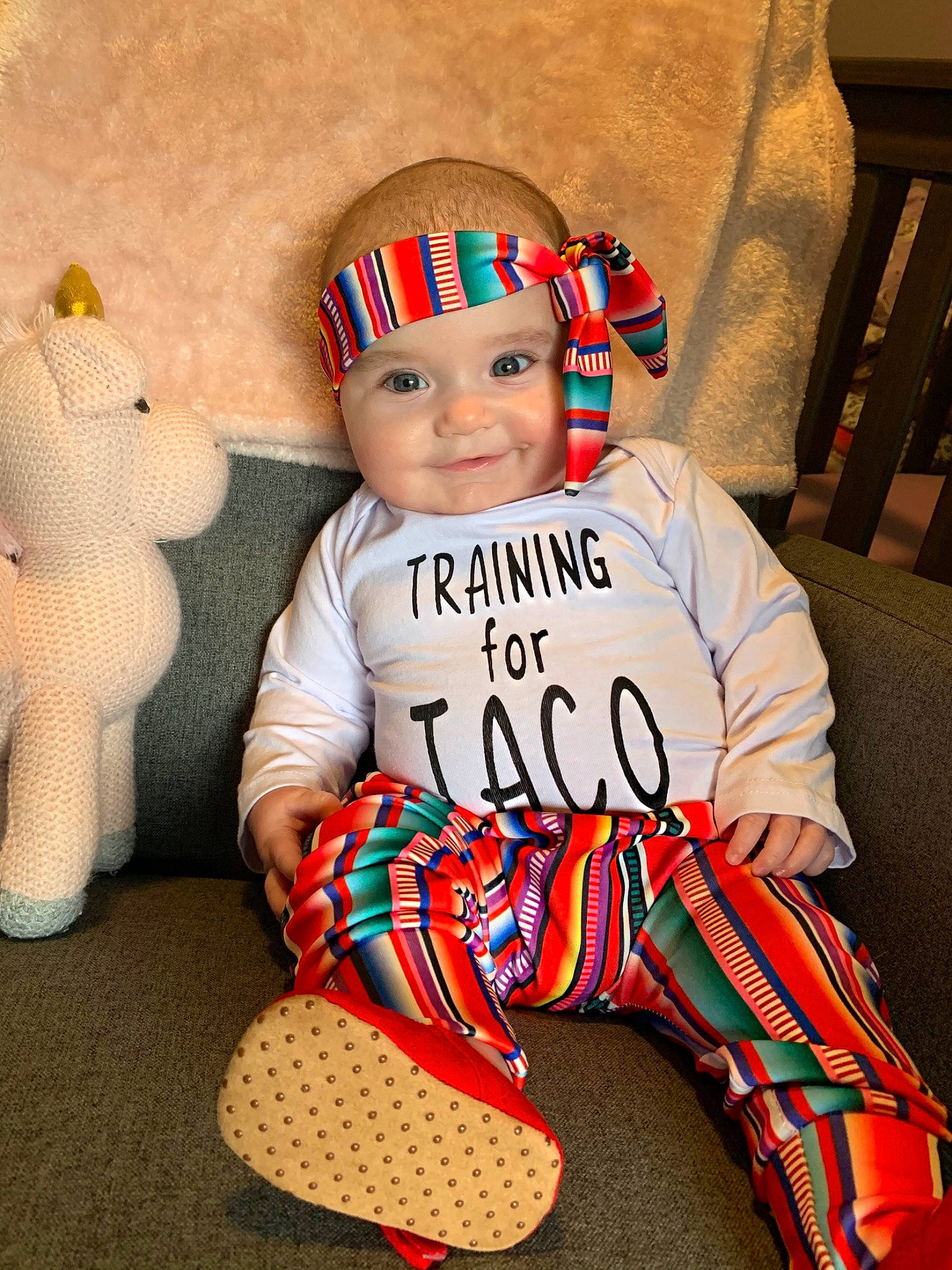 Giovanna is registered to the contest to win money with this photo: baby, baby_toddler_clothing, child, costume, design, head, headgear, headwear, joy, pajamas, pattern, person, plaid, shoe, sitting, textile, toddler
