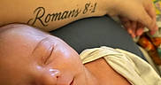 Woodrow is registered to the contest to win money with this photo: baby, sleeping, infant, arm, tattoo, romans_8_1, skin, blanket, clothing, closeup, peaceful, rest, comfort, person, newborn, soft, indoors, cute, portrait, child