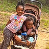 child, baby, stroller, outdoor, forest, smiling, girl, infant, nature, happy, clothing, footwear, grass, family, cute, toddler, playful, leisure, sunlight, trees