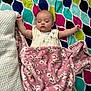 Noelle joined the competition — help win amazing prizes! baby, sleeping, blanket, pillow, floral_pattern, colorful, pink, white, patterned, cozy, infant, resting, soft, child, peaceful, bedroom, cute, portrait, relaxation, indoor