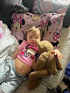 Symphony Wells joined the competition — help win amazing prizes! baby, baby_products, baby_toddler_clothing, bedding, cheek, child, comfort, fun, human_leg, knee, lap, linens, person, room, sitting, skin, sleeve, t_shirt, textile, thigh