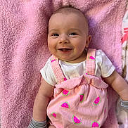 Oakley is registered to the contest to win money with this photo: baby, infant, smile, pink_blanket, pink_outfit, watermelon_pattern, mittens, happy, cute, lying_down, child, face, portrait, soft_texture, apparel, cheerful, young_child, skin, head, expression