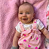 baby, infant, smile, pink_blanket, pink_outfit, watermelon_pattern, mittens, happy, cute, lying_down, child, face, portrait, soft_texture, apparel, cheerful, young_child, skin, head, expression