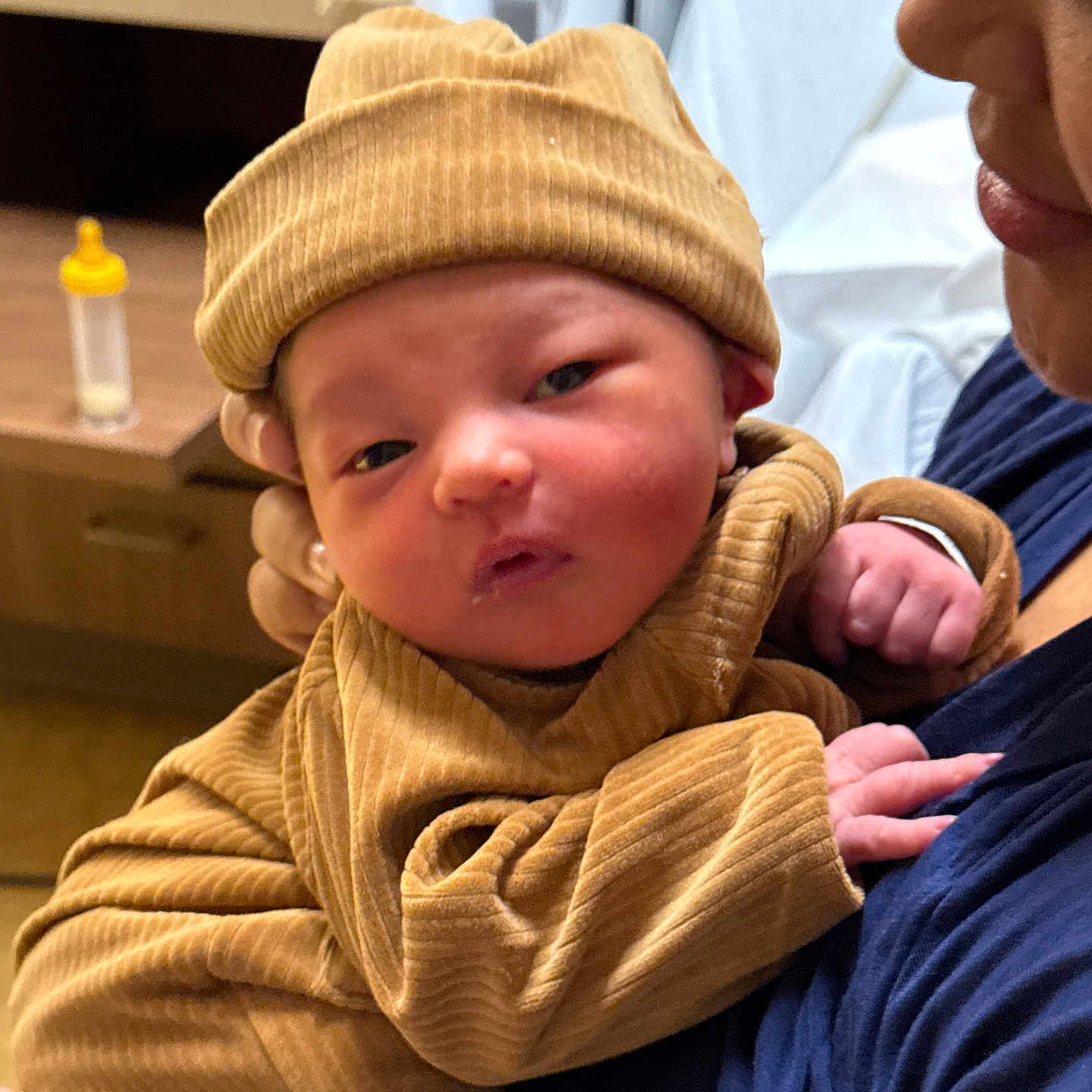 Shella joined the competition — help win amazing prizes! arm, baby, beanie, bedside_table, blanket, bottle, cheeks, closeup, cuddle, face, hat, holding, hospital_room, infant, newborn, onesie, parent, portrait, ribbed_clothing, skin