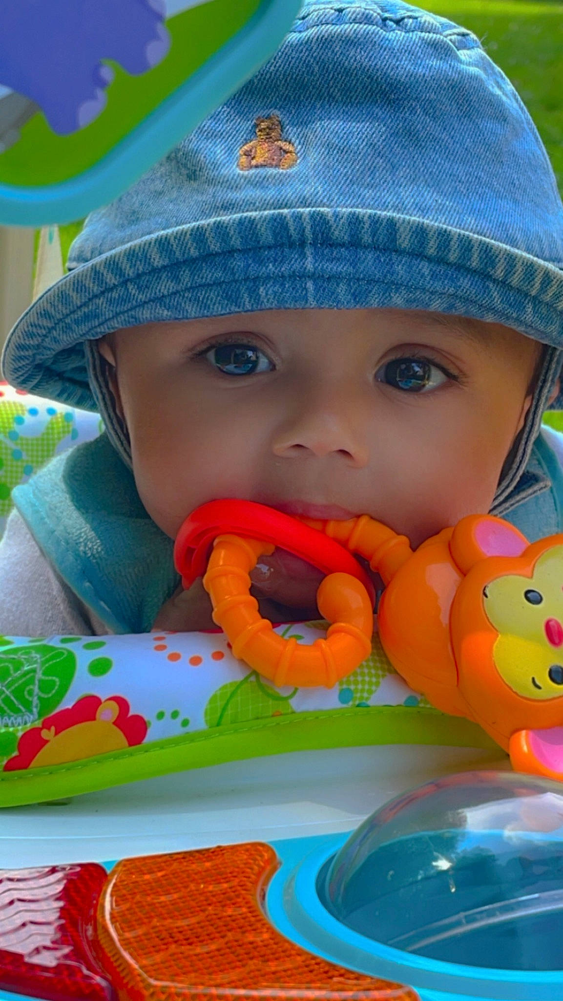 Jakari is registered to the contest to win money with this photo: baby, baby_playing_with_toys, baby_toddler_clothing, beauty, blue, cap, child, face, fun, grass, happy, hat, headwear, mouth, orange, person, play, product, skin, sun_hat