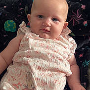 Lyla joined the competition — help win amazing prizes! baby, infant, romper, floral_pattern, bunny_print, blanket, galaxy_pattern, blue_eyes, skin, face, chubby_cheeks, arm, hand, soft_light, indoor, portrait, clothing, comfort, lying_down, cute