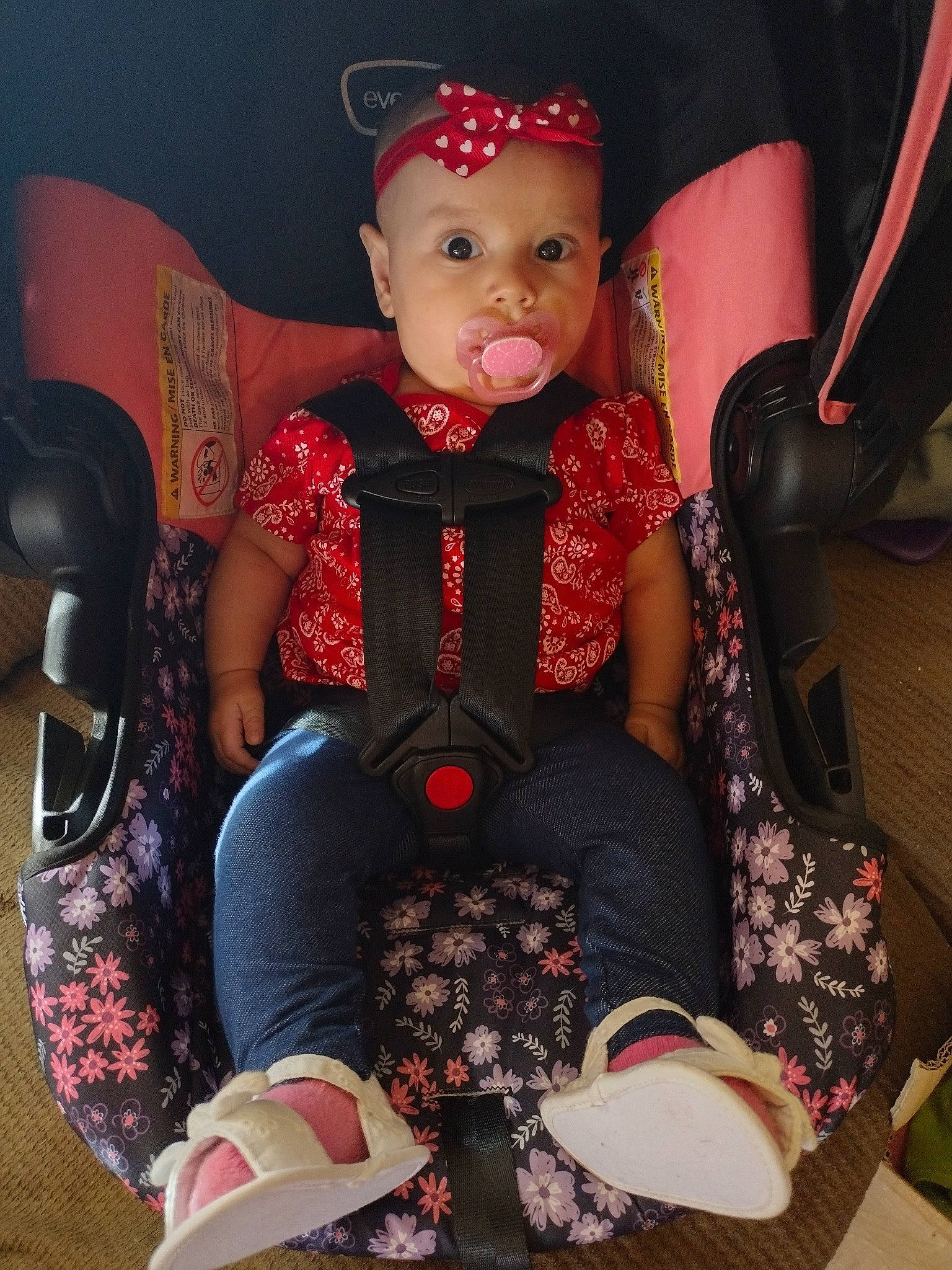 Evelyn is registered to the contest to win money with this photo: baby, baby_toddler_clothing, carmine, child, comfort, embellishment, fashion_accessory, foot, headwear, human_leg, knee, lap, magenta, pattern, person, pink, sitting, sleeve, sock, thigh