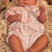 Arizona joined the competition — help win amazing prizes! baby, infant, portrait, pink_outfit, bonnet, lace, floral, flowers, vintage, seated, lying_down, smiling, face, hands, legs, dress, baby_clothing, indoor, warm_lighting, ornate_decor