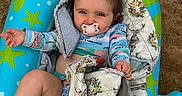 Everlee is registered to the contest to win money with this photo: baby, infant, pacifier, blue_inflatable, pool_float, quilt, patchwork, deer_pattern, floral_pattern, sandy_background, child, smiling, playful_hairstyle, barefoot, outdoor, relaxed, colorful_clothing, blanket, cute, portrait