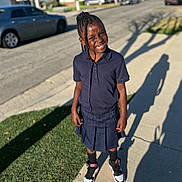 Samiyah joined the competition — help win amazing prizes! backpack, braids, cars, child, daylight, fashion, grass, happy, houses, outdoor, portrait, school_uniform, shadow, shoes, sidewalk, smiling, standing, street, suburban, sunny