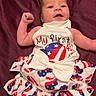 baby, infant, clothing, dress, bow, flag_pattern, patriotic, red, white, blue, blanket, lying_down, cute, happy, person, skin, celebration, holiday, american_flag, portrait
