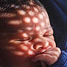 Rudra is registered to the contest to win money with this photo: baby, infant, face, hand, thumb, sleeping, closeup, shadow, light_pattern, skin, peaceful, newborn, portrait, cute, soft_light, expression, tiny_fingers, calm, child, blue_clothing