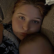 Franklin is registered to the contest to win money with this photo: woman, child, face, portrait, close_up, couch, indoors, relaxing, family, skin, hair, expression, casual, comfort, togetherness, head, young_child, adult, texture, resting