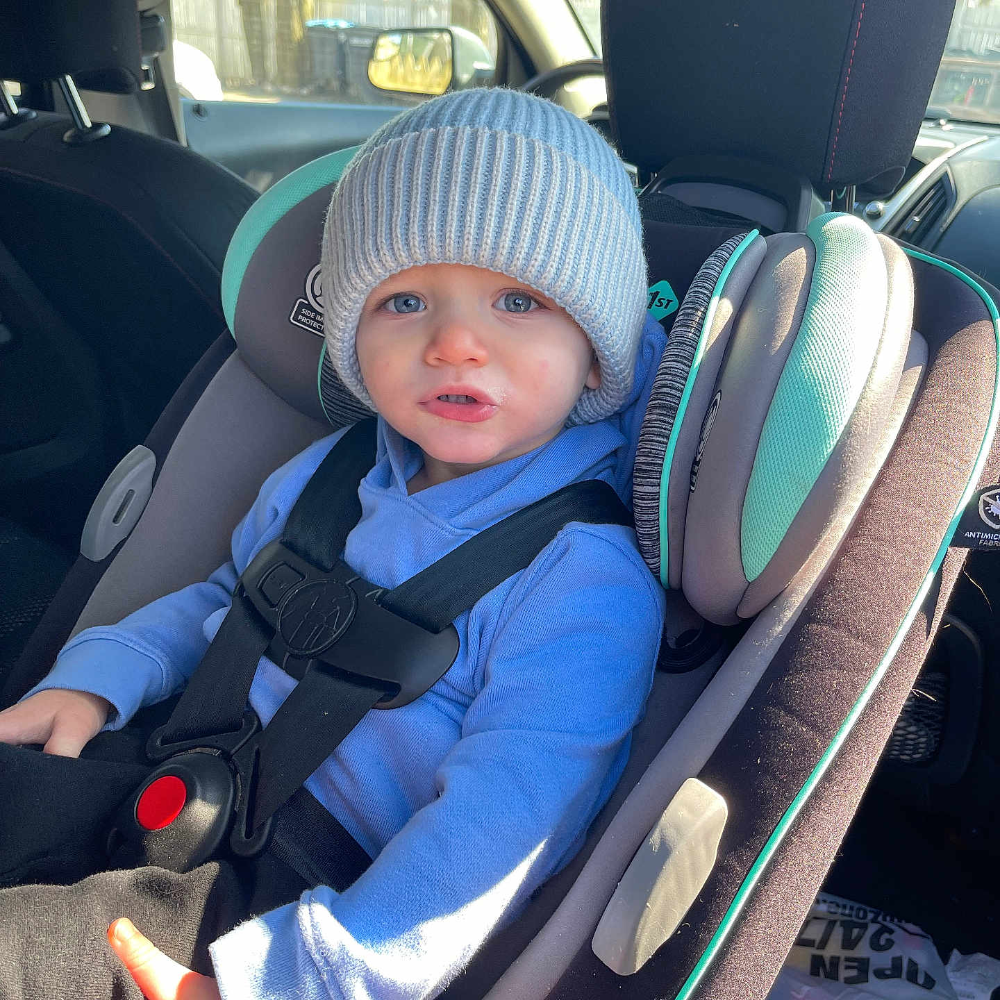 Owen is registered to the contest to win money with this photo: baby, bodypart, cap, car, car_interior, chair, clothing, cushion, face, finger, furniture, hand, hat, head, homedecor, person, photography, portrait, transportation, vehicle