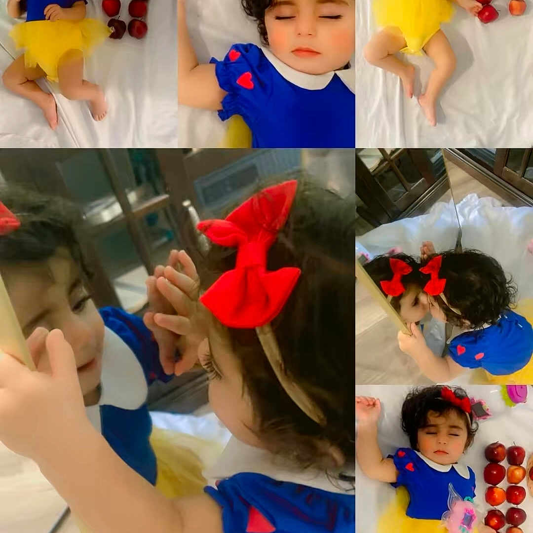 Elia is registered to the contest to win money with this photo: child, toddler, girl, snow_white_costume, blue_dress, yellow_skirt, red_bow, apples, bed, bedding, portrait, collage, mirror_selfie, sleeping, indoors, smiling, curly_hair, hair_accessory, toy, family_photo