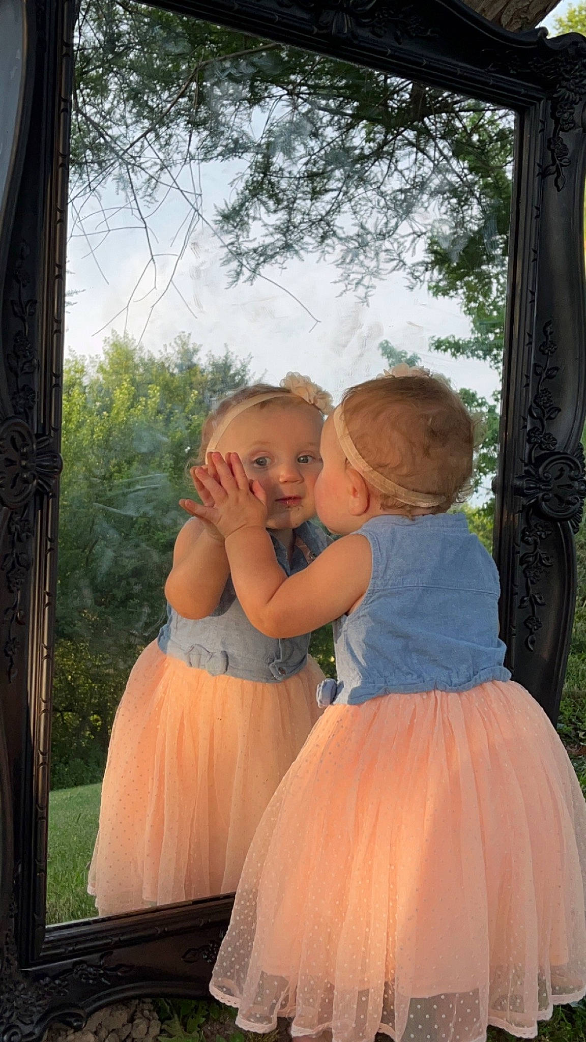 Claire is registered to the contest to win money with this photo: bridal_clothing, bridal_party_dress, child, event, flash_photography, formal_wear, fun, gown, happy, human_body, people_in_nature, person, pink, plant, shoulder, sky, standing, toddler, tree, waist